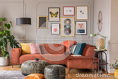 Vintage black poufs in trendy eclectic living room interior with brown couch Stock Photo