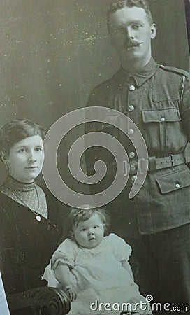 Vintage black and white photo of a family portrait with man in uniform possibly World War 1900s. Editorial Stock Photo