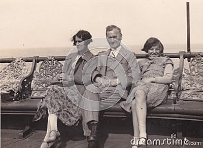 Vintage black and white photo of a family at the seaside. 1950s Editorial Stock Photo