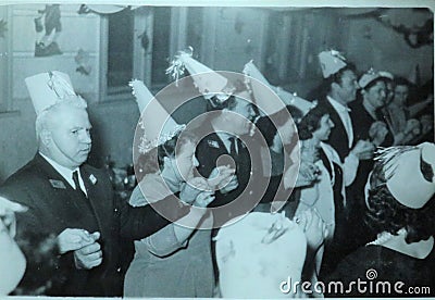 Vintage black and white photo of people at a party dancing and wearing funny hat, Christmas Party? 1950s European. Editorial Stock Photo