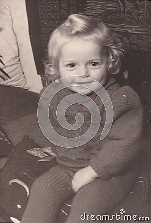 Vintage black and white photo of a young child smiling 1940s? Editorial Stock Photo