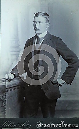 Vintage black and white photo of a young Victorian man with moustache wearing smart suit and big collar shirt 1880s - 1900s. Editorial Stock Photo