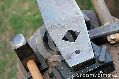 Vintage blacksmith tools on wooden table Stock Photo