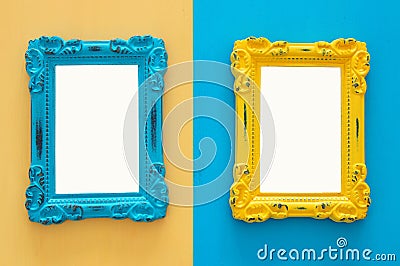 Vintage blank blue and yellow photo frames over double colorful background. Ready for photography montage. Top view from above. Stock Photo