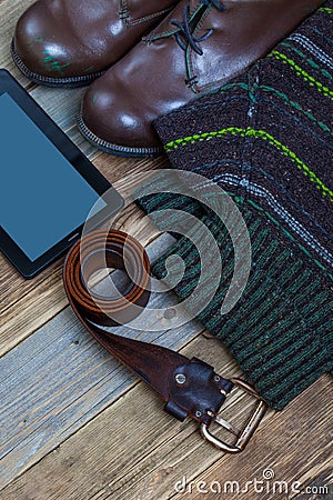 Vintage boots, leather belt, sweater and digitizer Stock Photo