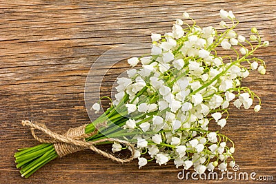 Vintage bouquet of wild flowers, the white scented lilies of the valley on an old wooden plank Stock Photo