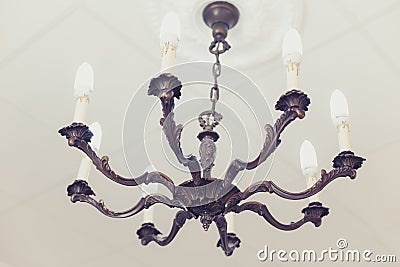 Vintage bras chandelier with economical bulbs Stock Photo