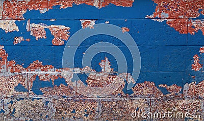 Vintage brick wall background. Brick texture with several layers of peeled paint. Stock Photo