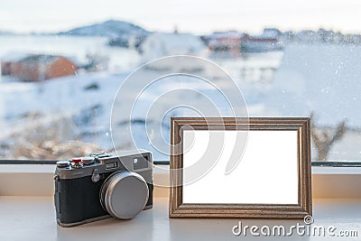 Vintage Camera with blank picture frame on window sill Stock Photo