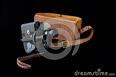 Vintage camera displayed on a black background beside a brown carry case Stock Photo