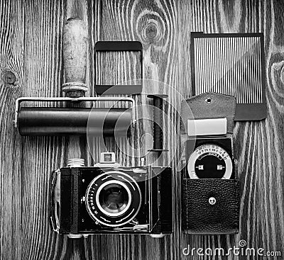 Vintage camera,exposure meter and another trappings of film photography. photographer`s desk. Stock Photo