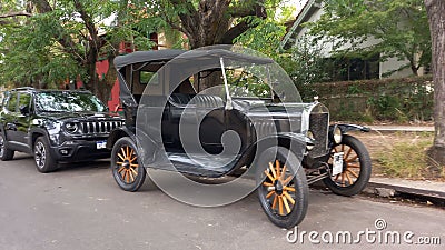 Vintage car black 1920s Ford Model T double phaeton parked in the street. Trees in the background. Editorial Stock Photo