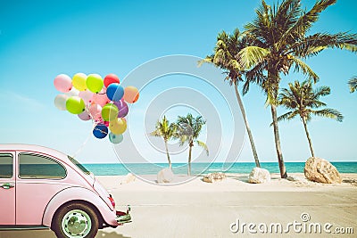 Vintage car with colorful balloon on tropical beach Stock Photo