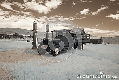 Vintage car at gas pumps in Bodie, California in infrared Stock Photo