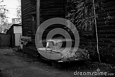 Vintage car near the wooden hause in Tomsk, Siberia. Stock Photo