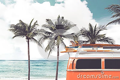 Vintage car parked on the tropical beach seaside with a surfboard on the roof Stock Photo