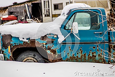 Vintage cars and trucks sit idle on a lot. Big Valley Alberta Canada Editorial Stock Photo