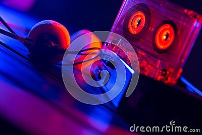 Vintage cassette tape player in neon light. 80s - 90s advertisement style. Disco party nostalgy concept Stock Photo