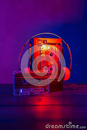 Vintage cassette tape player in neon light. 80s - 90s advertisement style. Disco party nostalgy concept Stock Photo
