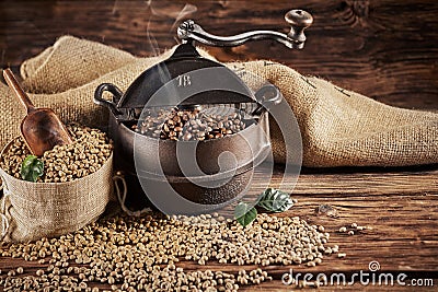 Vintage cast iron coffee roaster with raw beans Stock Photo