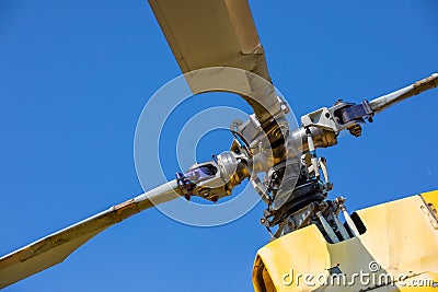 Vintage Charm: The Weathered Rotors of a Yellow Old Helicopter Unveil Aviation History Stock Photo