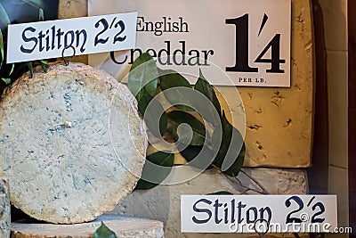 Vintage cheese shop mock-up. Old English stilton and cheddar dis Editorial Stock Photo