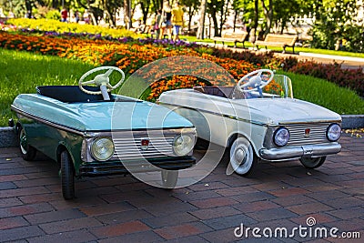 Vintage children`s pedal blue and white cars Moskvich Editorial Stock Photo