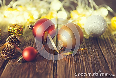 Vintage Christmas background with christmas baubles on wooden background over christmas lights Stock Photo