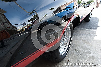 Vintage classic car with reflection of the street on its surface Editorial Stock Photo