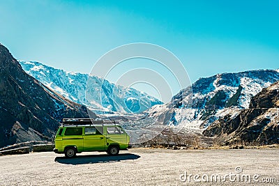 Caucasus Vintage classic van parked beside the road among the high Caucasus peaks on the far north of Georgia. Breath taking view Editorial Stock Photo