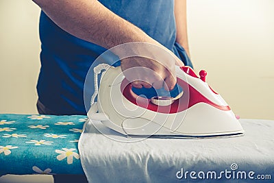 Vintage close up of male hand and iron ironing Stock Photo