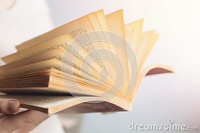 Vintage close up of an old open book with yellow pages. Avid reader, bookworm concept Stock Photo