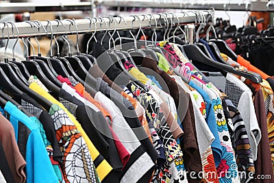 Vintage clothes of many colors for sale at flea market Stock Photo