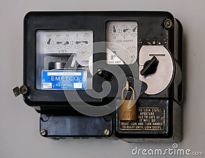 Vintage coin in the slot electricity meter. Editorial Stock Photo