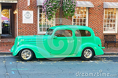 Vintage collectible BMW 327 is parked outside a cafe in an old town in Virginia Editorial Stock Photo