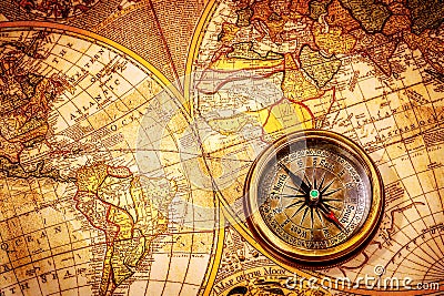 Vintage compass lies on an ancient world map. Stock Photo