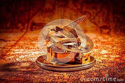 Vintage compass lies on an ancient world map. Stock Photo