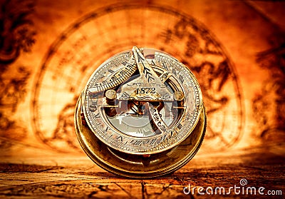 Vintage compass lies on an ancient world map. Stock Photo