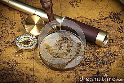 Vintage Compass, magnifying glass and spyglass telescope lies on an ancient world map - adventure stories background Stock Photo