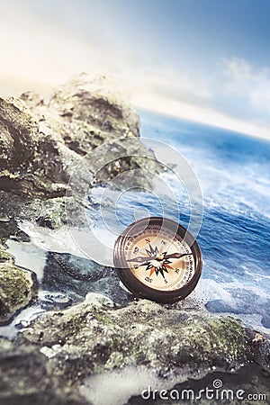 Vintage compass on the sea shore Stock Photo