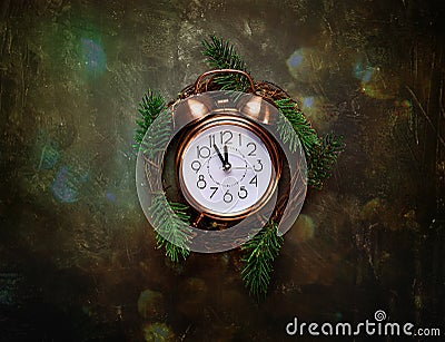 Vintage Copper Alarm Clock Five Minutes to Midnight New Years Countdown Christmas Wreath Fir Tree Branches on Black Background Gli Stock Photo