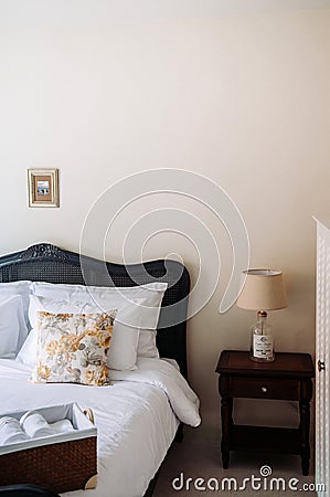 Vintage cozy country home bedroom decoration with classic wooden bed Editorial Stock Photo