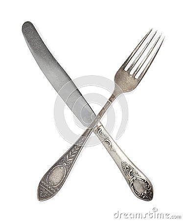 Vintage crossed spoon and fork isolate on white background. Stock Photo