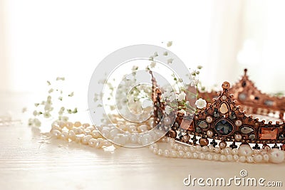 Vintage crown and pearls necklace. Wedding concept. Back light Stock Photo