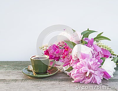 Vintage cup of coffee and bouquet ofn puprle peonies Stock Photo