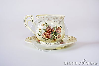 Vintage cup of tea with saucer isolated on white background ,Antique tea cup with rose pattern English style Stock Photo
