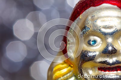 Vintage decorative christmas bauble in a shape of a crown jester against a colorful bokeh blury star background Stock Photo