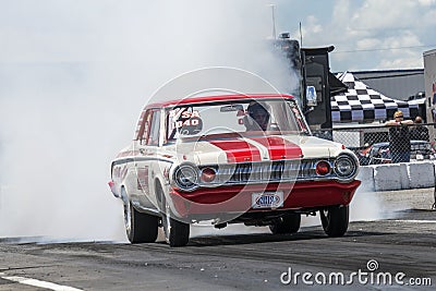 Vintage drag car making a smoke show on the track Editorial Stock Photo