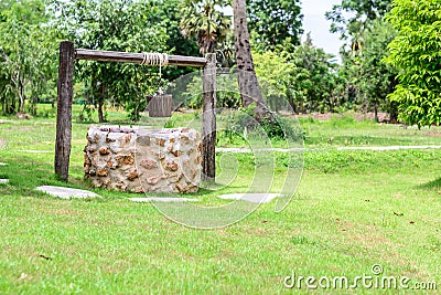 Vintage draw well with wooden drive shaft bucket Stock Photo