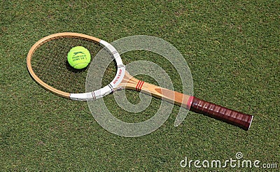 Vintage Dunlop tennis racket and Slazenger Wimbledon Tennis Ball on the grass tennis court. Editorial Stock Photo